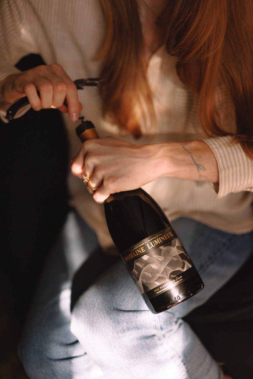 Domaine Lumineux bottle of wine being opened.