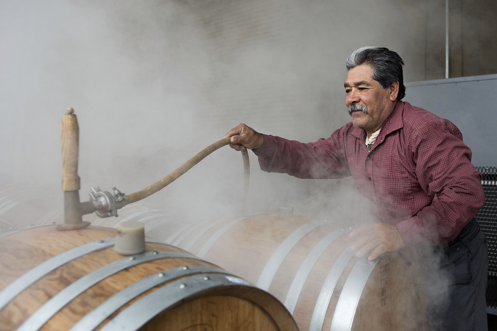 A man steams wine barrels